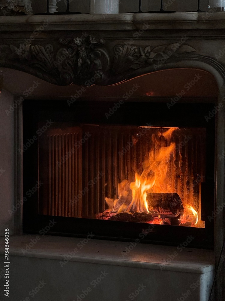 Close-Up of a Lit Fireplace with Ornate Mantel Close-Up of a Lit Fireplace with Ornate Mantel