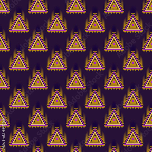 Seamless geometric triangle shapes pattern on dark background.