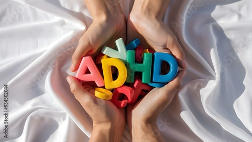 Hands Holding ADHD Colorful Plastic Letters in Support photo