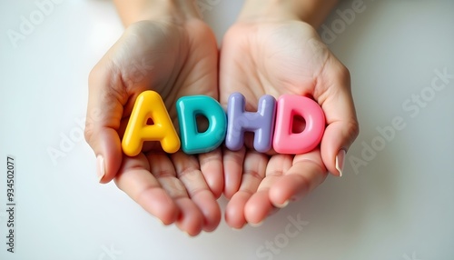 Hands Holding ADHD Colorful Plastic Letters in Support photo