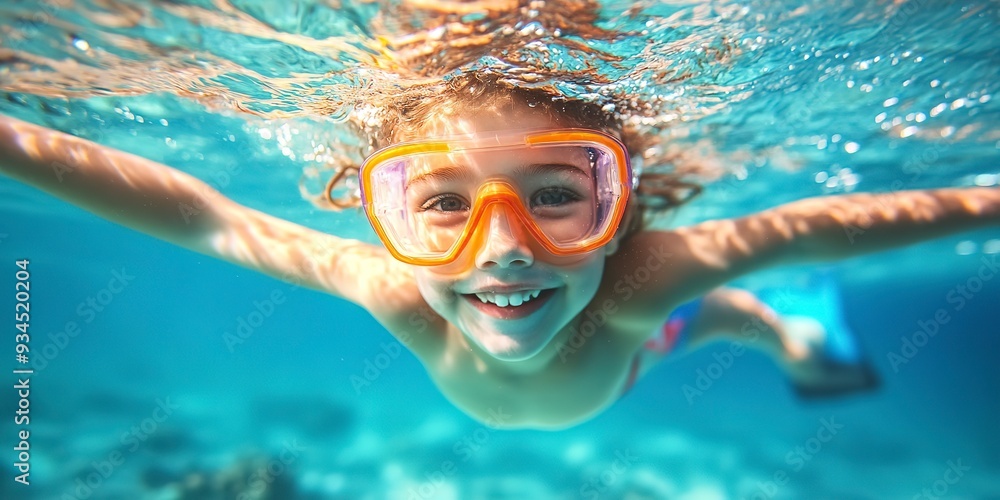 Fototapeta premium A happy child swimming underwater on summer vacation. 