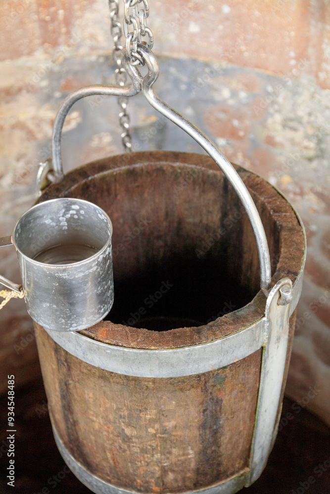 Europe, Romania. Bukovina, Moldovita, Renown for painted monasteries. Well. Wood bucket and metal drinking cup. Europe, Romania. Bukovina, Moldovita, Renown for painted monasteries. Well. Wood bucket and metal drinking cup.