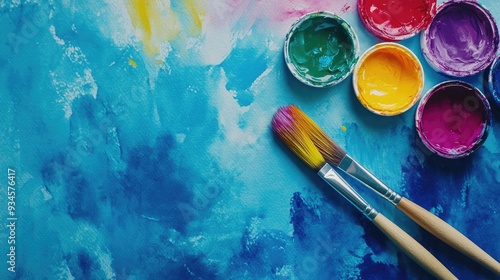 Watercolor illustration for Back to School featuring vibrant paints and a brush on a bold blue background Ample copy space Overhead view photo