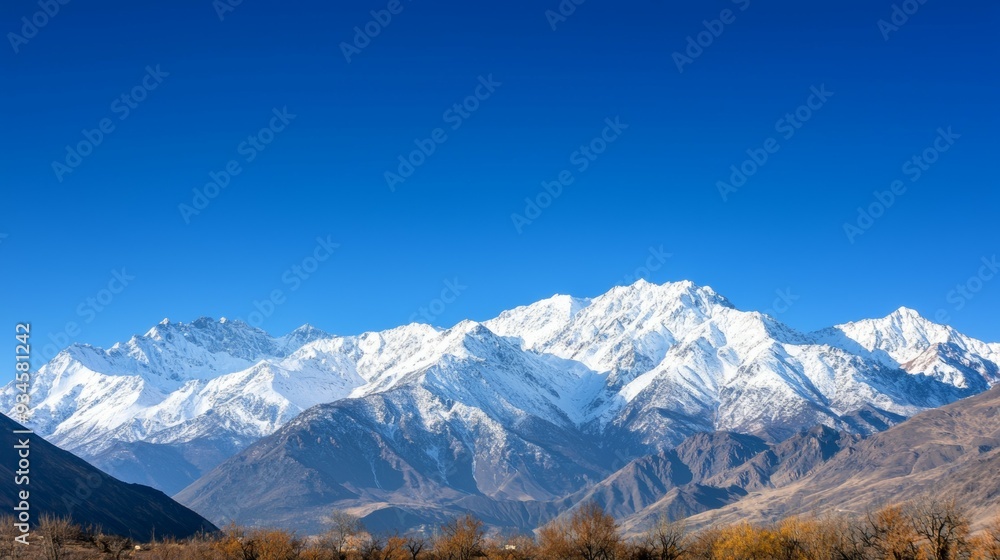 Majestic mountain range with snow-capped peaks and clear blue sky above. Majestic Mountain Range Majestic mountain range with snow-capped peaks and clear blue sky above. Majestic Mountain Range