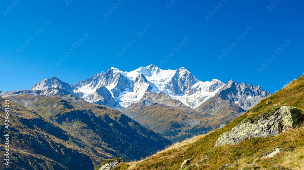 Majestic mountain range with snow-capped peaks and clear blue sky above. Majestic Mountain Range