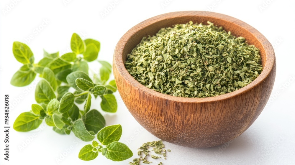 A wooden bowl filled with dried oregano flakes, with sprigs of fresh oregano leaves nearby, perfectly isolated on a white background. A wooden bowl filled with dried oregano flakes, with sprigs of fresh oregano leaves nearby, perfectly isolated on a white background.