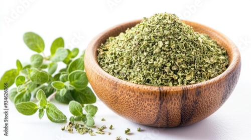 A wooden bowl filled with dried oregano flakes, with sprigs of fresh oregano leaves nearby, perfectly isolated on a white background.