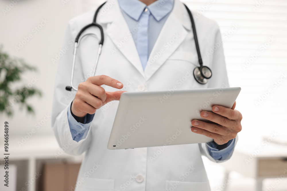 Doctor using tablet in hospital, closeup view Doctor using tablet in hospital, closeup view