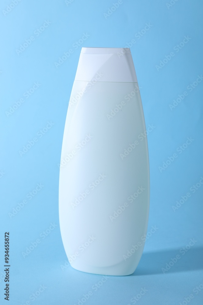 Shampoo in container on light blue background. Personal care product Shampoo in container on light blue background. Personal care product