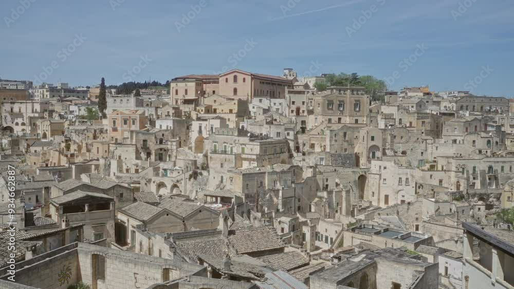 A stunning panoramic view of the traditional stone houses in matera, basilicata, italy on a bright sunny day. A stunning panoramic view of the traditional stone houses in matera, basilicata, italy on a bright sunny day.