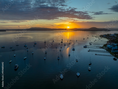 Aerial sunrise waterscape with boats, clouds and reflections photo