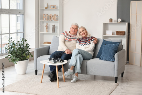 Happy mature couple sitting...