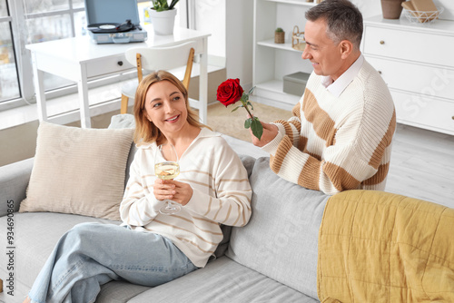 Mature couple with glass of...