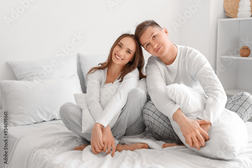 Young couple with pillows s...