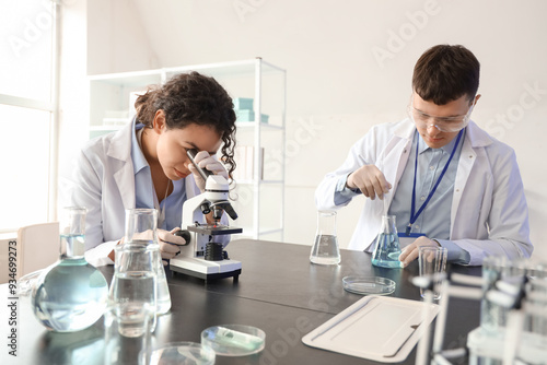 Young chemists with microsc...