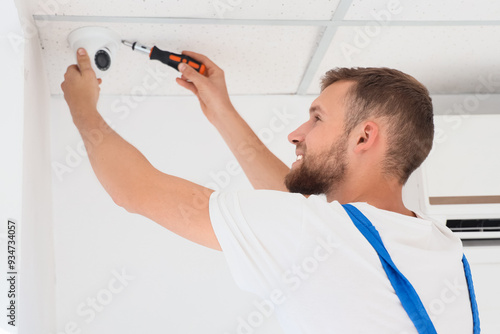 Male worker installing alar...