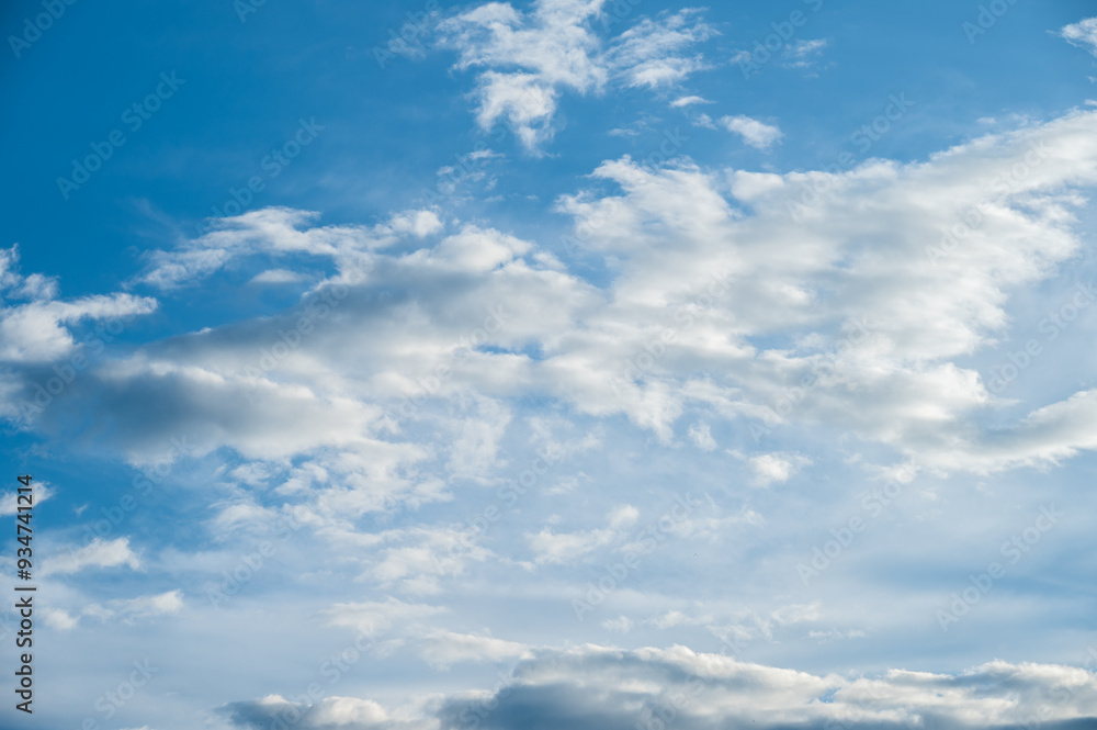 View of clouds floating on blue sky. During the day the sky looks blue because it's the blue light that gets scattered the most. View of clouds floating on blue sky. During the day the sky looks blue because it's the blue light that gets scattered the most.