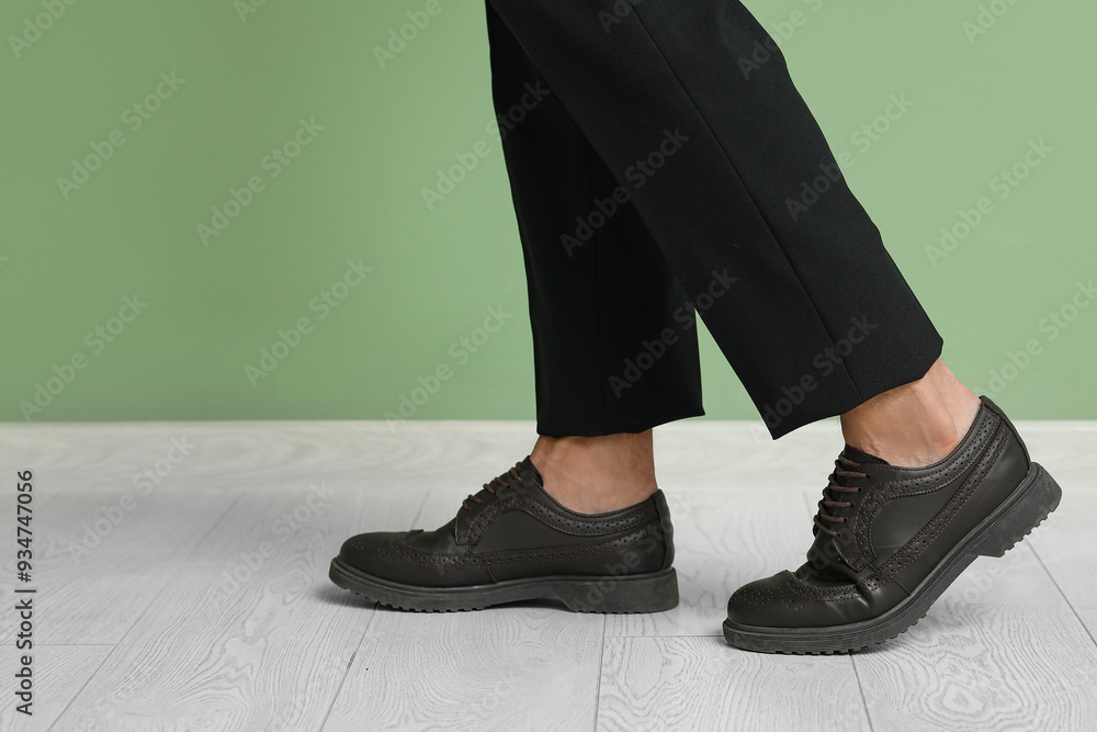 Stylish young businessman in elegant shoes near green wall, closeup Stylish young businessman in elegant shoes near green wall, closeup