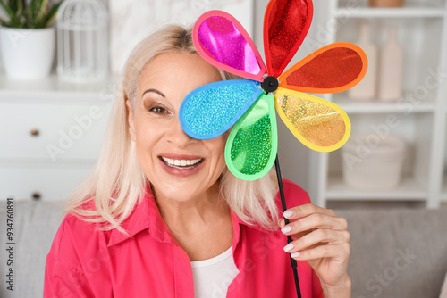 Mature woman with toy windm...