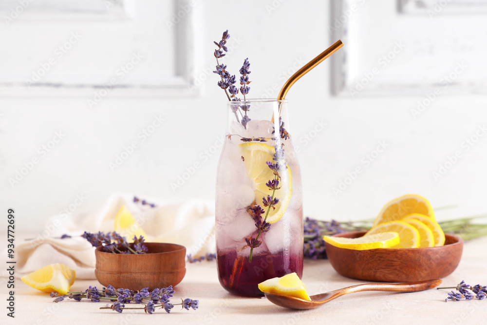 Bottle of fresh lavender lemonade with flowers and slices of lemon on white background Bottle of fresh lavender lemonade with flowers and slices of lemon on white background
