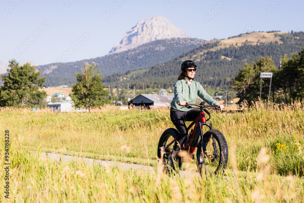 Fototapeta premium Woman Cycling in Scenic Crowsnest Pass Alberta Landscape