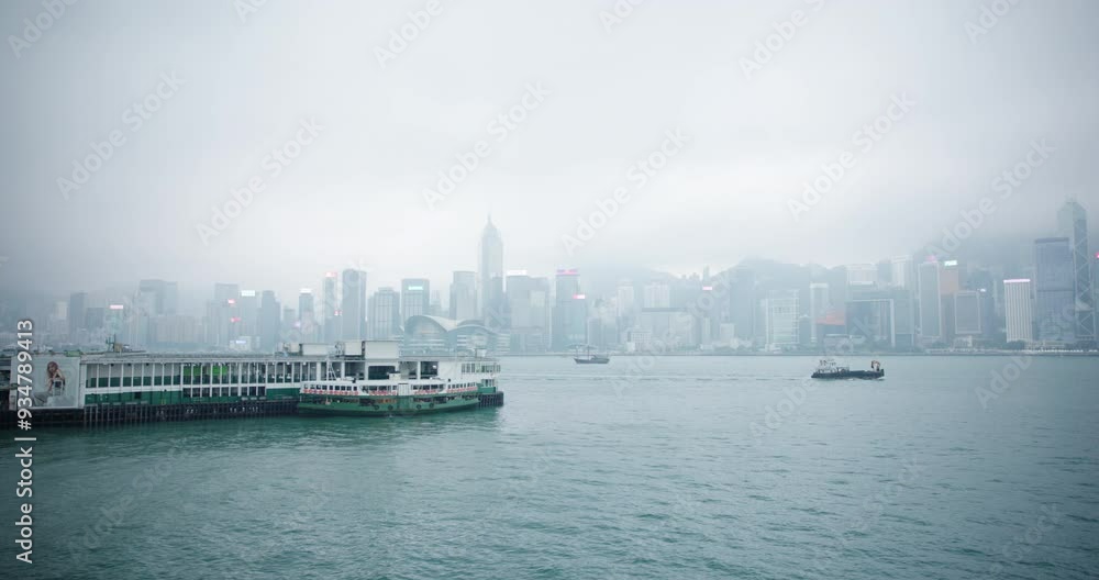 Pan Shot of Dock and Boats on Victoria Harbour with Foggy View of Hong Kong Skyscrapers in Background Pan Shot of Dock and Boats on Victoria Harbour with Foggy View of Hong Kong Skyscrapers in Background