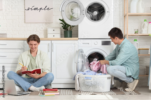 Male students studying in dorm laundry room