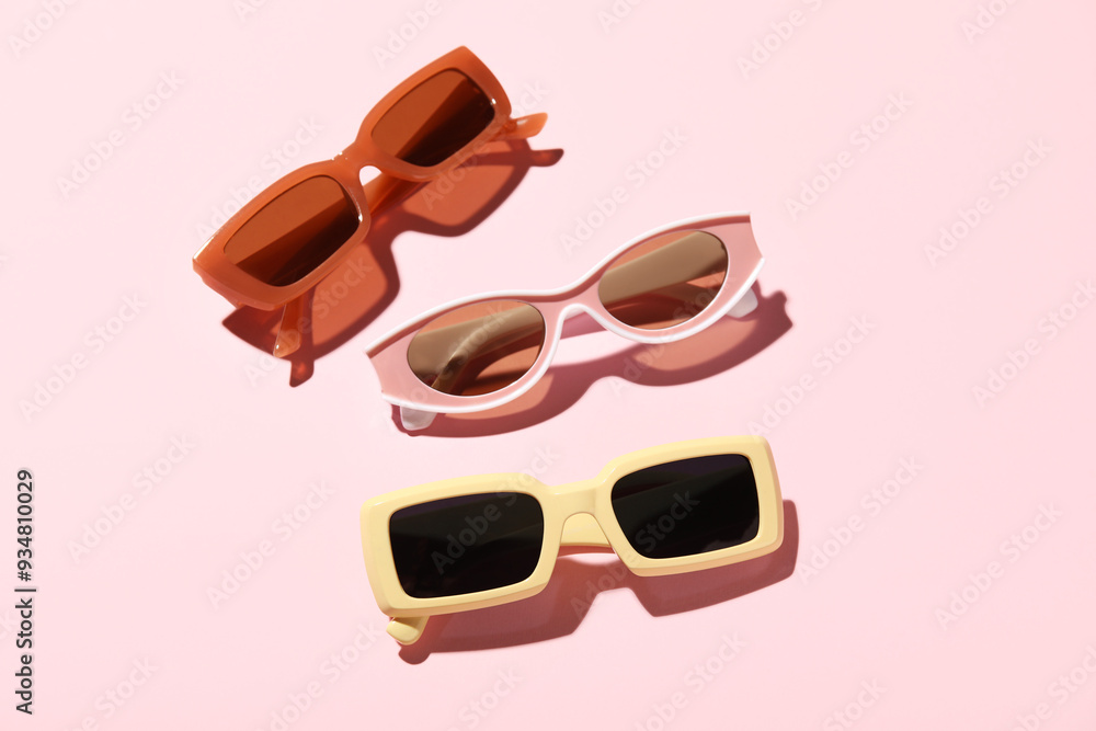 Different stylish sunglasses on pink background Different stylish sunglasses on pink background