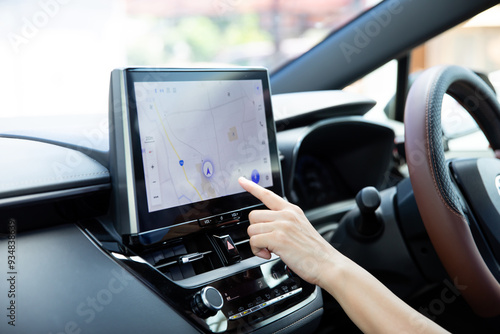 Hands operating the car navigation system
車のナビを操作する手元