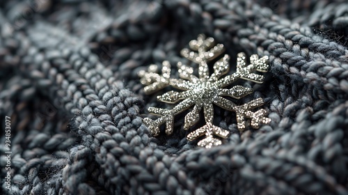 Gleaming snowflake on a background of deep gray wool