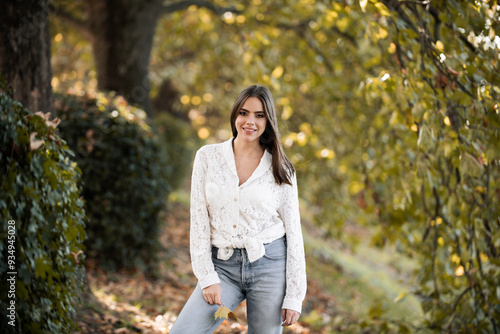 Autumn fall. Portrait young woman with autumn leafs on foliage. Beautiful girl outdoor in autumn. Sensual woman with yellow leaves in autumn. Pretty woman with leaf near face on autumnal background.