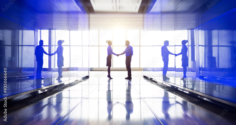 Business people shaking hand in the hallway Business people shaking hand in the hallway