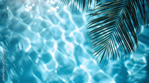 Palm leaves shadow on water surface in swimming pool, summer vacation.