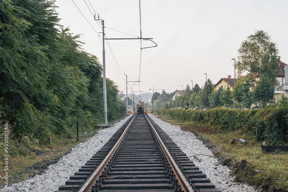 Fresh track and ballast on a track bed at a renovation works of a railway track. Morning view of a railway line that is being renovated Fresh track and ballast on a track bed at a renovation works of a railway track. Morning view of a railway line that is being renovated