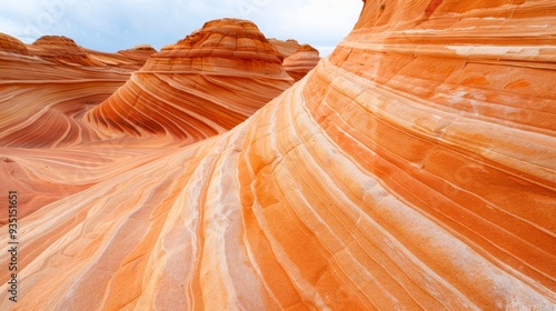  A vast desert rock formation under a blue sky with scattering white clouds