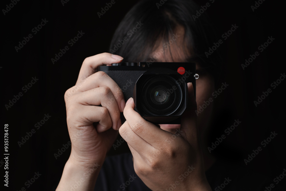 photographer take pictures Snapshot with camera. man hand holding with camera looking through lens.Concept for photographing articles Professionally. photographer take pictures Snapshot with camera. man hand holding with camera looking through lens.Concept for photographing articles Professionally.