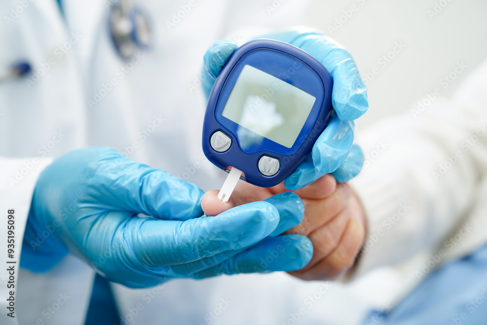 Asian doctor using digital glucose meter for check sample blood sugar level to treatment diabetes. Asian doctor using digital glucose meter for check sample blood sugar level to treatment diabetes.
