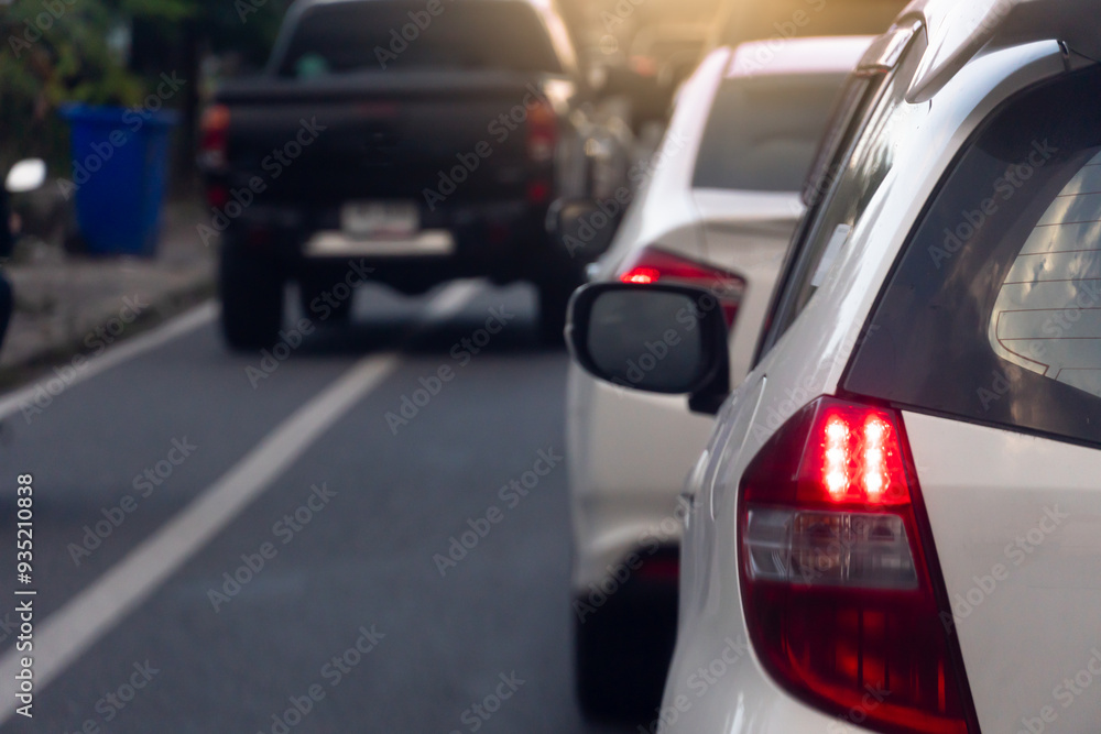 Rear side view of white car on the aspahlt road. Transtport of car turn on brake light in the business time environment of moring time. Traffic congestion and queues of cars. Rear side view of white car on the aspahlt road. Transtport of car turn on brake light in the business time environment of moring time. Traffic congestion and queues of cars.
