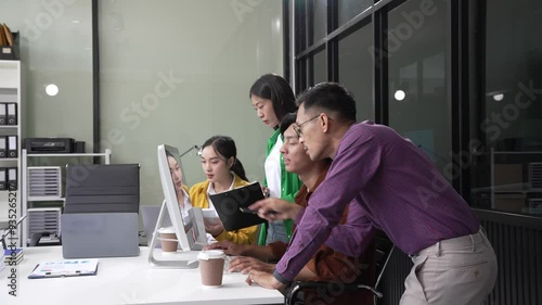 In a boardroom, an Asian team discusses startup financials and business terms. They present strategies on acquisitions, cash flow, and investor relations, innovative approaches for company growth. photo