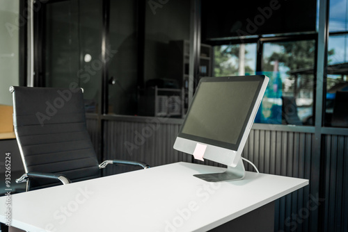 Wallpaper Mural A modern office desk with a laptop, monitor, and plant. sleek, minimal design features open space, technology and productivity. room is empty, offering a clean and organized workspace. Torontodigital.ca