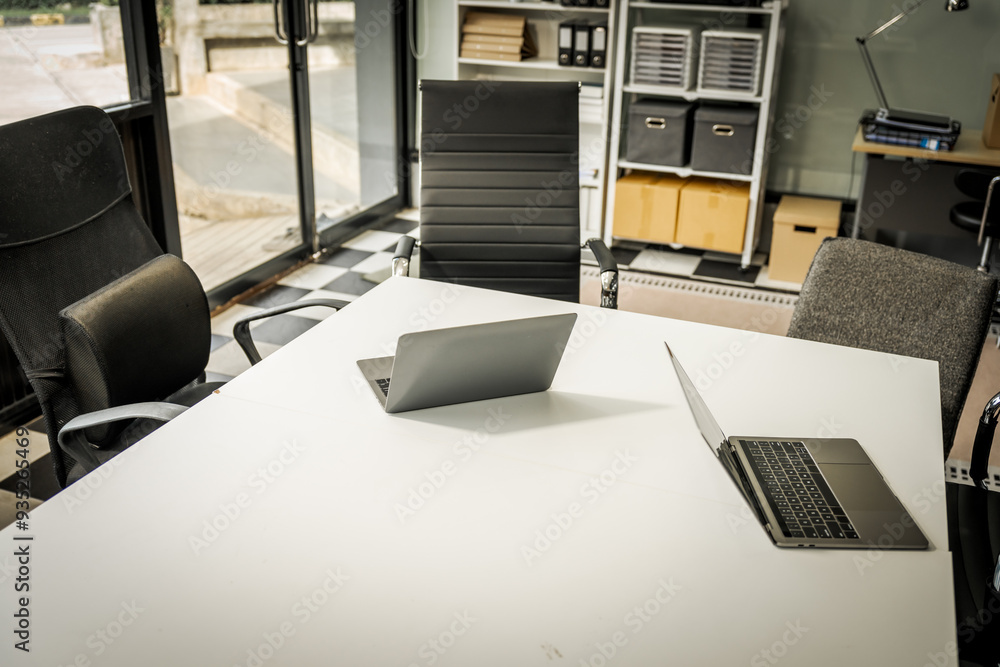 A modern office desk with a laptop, monitor, and plant. sleek, minimal design features open space, technology and productivity. room is empty, offering a clean and organized workspace. A modern office desk with a laptop, monitor, and plant. sleek, minimal design features open space, technology and productivity. room is empty, offering a clean and organized workspace.