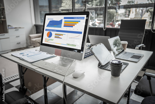 Wallpaper Mural A modern office desk with a laptop, monitor, and plant. sleek, minimal design features open space, technology and productivity. room is empty, offering a clean and organized workspace. Torontodigital.ca