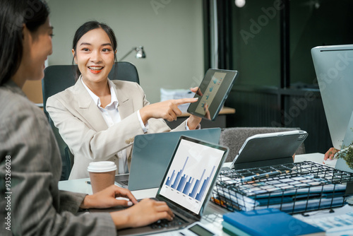 Wallpaper Mural Asian colleagues meet at a desk, discussing business financial terms, investment strategies, managing funds. Their focus is on planning, analysis, and operations to ensure stability and success. Torontodigital.ca