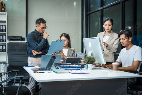 Fotografia Asian colleagues meet at a desk, discussing business financial terms, investment strategies, managing funds
