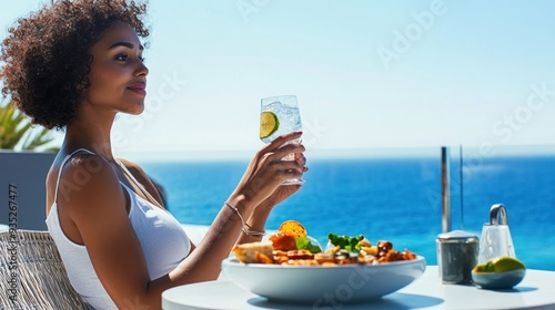 Woman enjoying a drink with ocean view dining