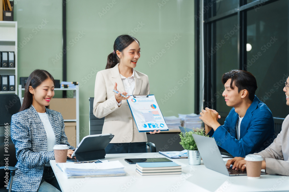 In a boardroom, an Asian team meets at a desk, presenting financial terms and strategies. Executives and employees collaborate, sharing ideas and work guidelines for success during an annual meeting. In a boardroom, an Asian team meets at a desk, presenting financial terms and strategies. Executives and employees collaborate, sharing ideas and work guidelines for success during an annual meeting.