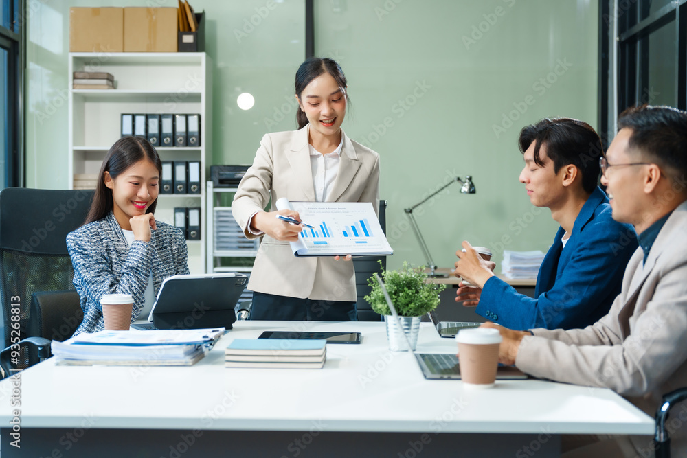 In a boardroom, an Asian team meets at a desk, presenting financial terms and strategies. Executives and employees collaborate, sharing ideas and work guidelines for success during an annual meeting. In a boardroom, an Asian team meets at a desk, presenting financial terms and strategies. Executives and employees collaborate, sharing ideas and work guidelines for success during an annual meeting.