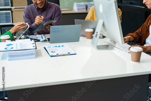 In a boardroom, an Asian team discusses startup financials and business terms. They present strategies on acquisitions, cash flow, and investor relations, innovative approaches for company growth. photo