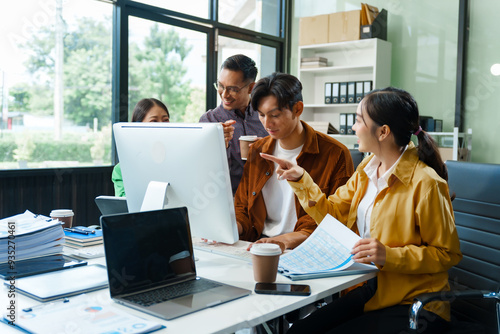 In a boardroom, an Asian team discusses startup financials and business terms. They present strategies on acquisitions, cash flow, and investor relations, innovative approaches for company growth. photo