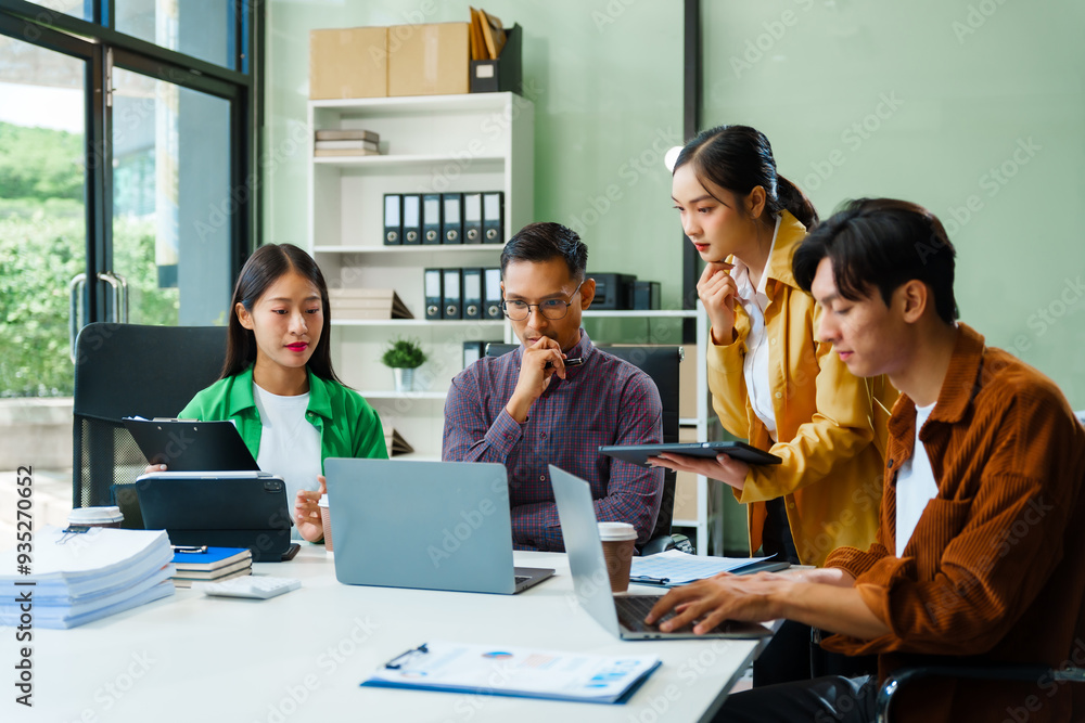 In a boardroom, an Asian team discusses startup financials and business terms. They present strategies on acquisitions, cash flow, and investor relations, innovative approaches for company growth. In a boardroom, an Asian team discusses startup financials and business terms. They present strategies on acquisitions, cash flow, and investor relations, innovative approaches for company growth.